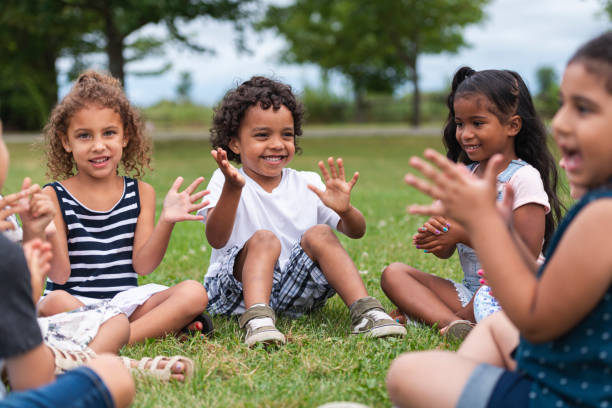 istock A Multi-Ethnic Group of Young Children are Clapping Outside 1165422413