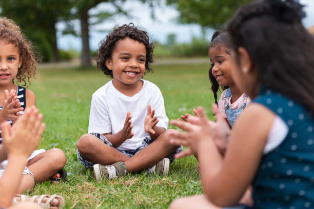 istock A Multi-Ethnic Group of Young Children are Clapping Outside 1165422415
