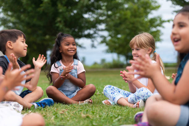 istock A Multi-Ethnic Group of Young Children are Clapping Outside 1165422417