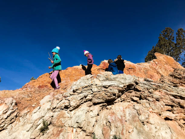 istock Children playing and exploring on beautiful red rock 1165423359
