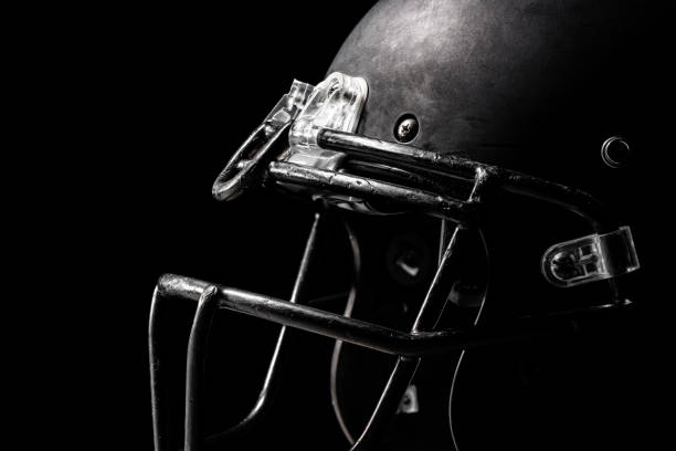 Football helmet on black background. Football helmet on black background. football helmet and ball stock pictures, royalty-free photos & images