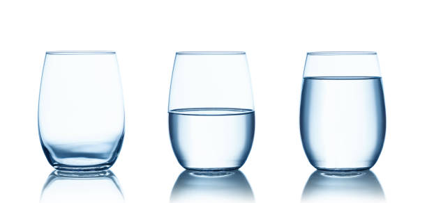 istock Empty,half and full water glasses . Isolated on white 1165424284