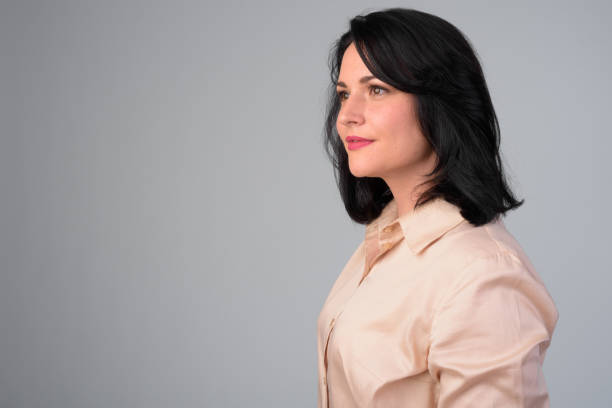 Profile view of beautiful businesswoman against white background Studio shot of beautiful businesswoman against white background isolated businesswoman isolated on white beauty stock pictures, royalty-free photos & images