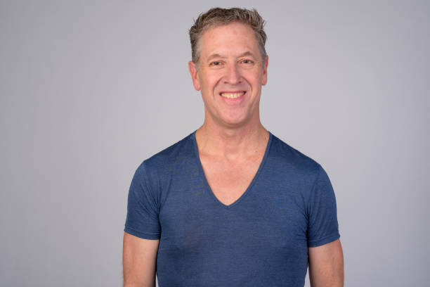 istock Happy mature man smiling against white background 1165425365