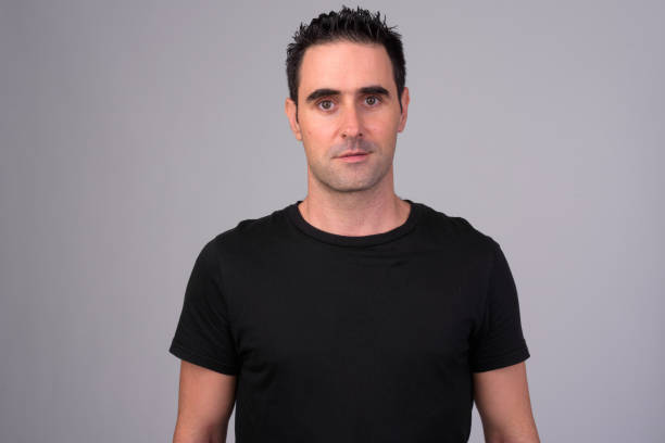 istock Portrait of handsome man against white background 1165426403