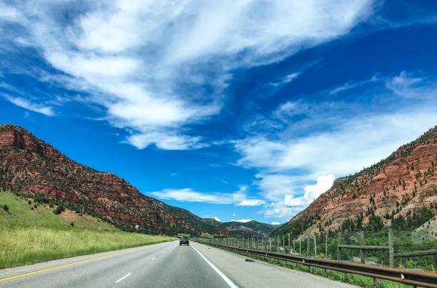istock road driving through red cliffs in colorado rocky mountains 1165427428
