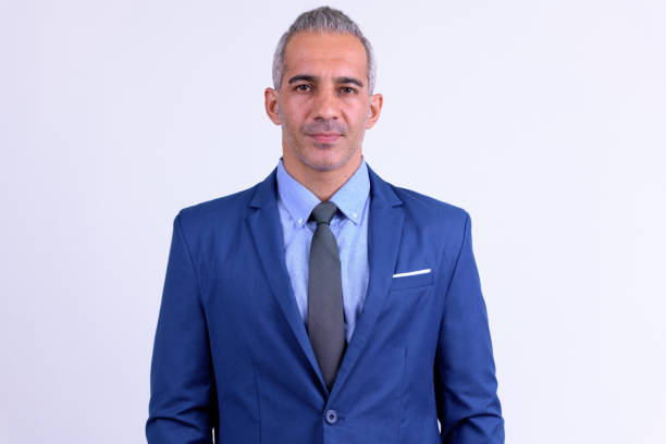Studio shot of handsome Persian businessman with suit against white background