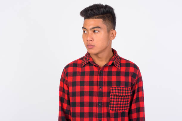 istock Young Asian hipster man thinking against white background 1165428449