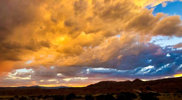 istock golden sunset clouds over rocks 1165428662