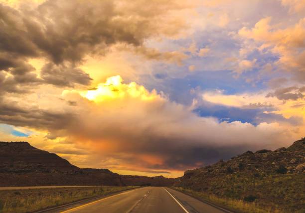 istock bright sunset clouds at end of road 1165428685