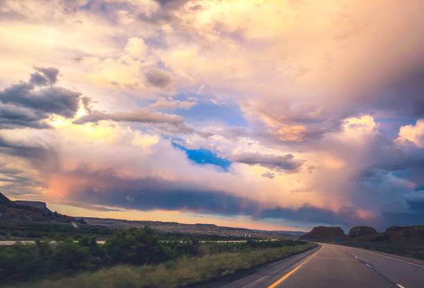 istock road leading to stormy sunset 1165428699
