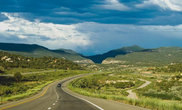 road winding toward shadowy mountains
