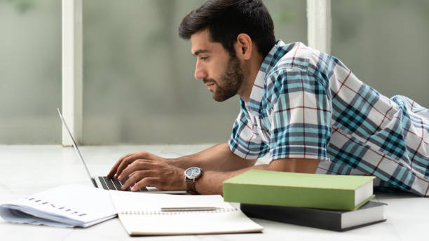 istock freelance businessman working at home while studying in university and doing research homework 1165429347