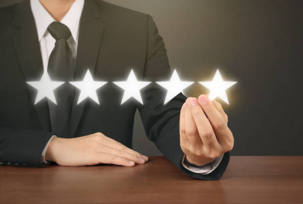 istock Hand touching five star symbol to increase rating 1165430574