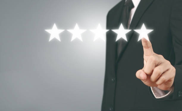 istock Hand touching five star symbol to increase rating 1165430576