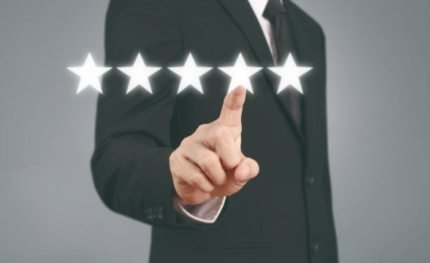 istock Hand touching five star symbol to increase rating 1165430579