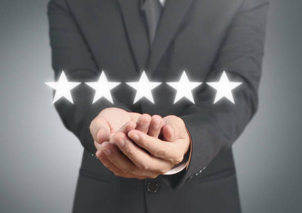 istock Hand touching five star symbol to increase rating 1165430580