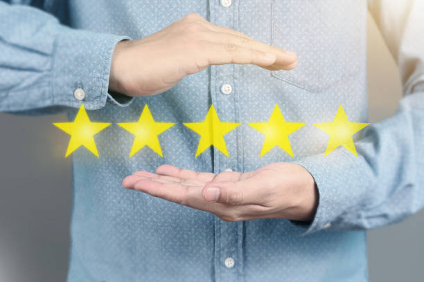 istock Hand touching five star symbol to increase rating 1165430582