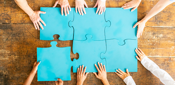 Top view panorama banner of business team assembling jigsaw puzzle over table symbolize business partnership and collective teamwork for HR recruitment and job seeker background. Shrewd