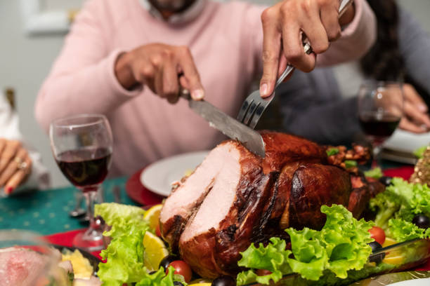istock Close-up on a man cutting the turkey on Thanks Giving dinner 1165436131