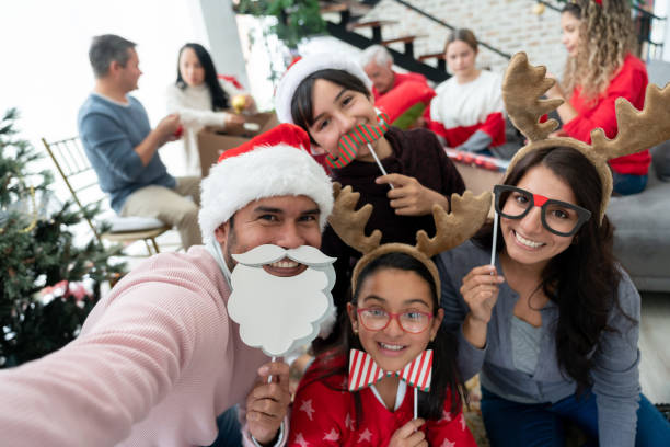 Family taking a selfie on Christmas Day using props