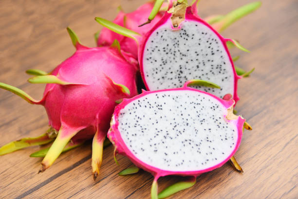 istock Dragon fruit slice on wooden background - Fresh pitaya summer tropical fruit concept 1165438374