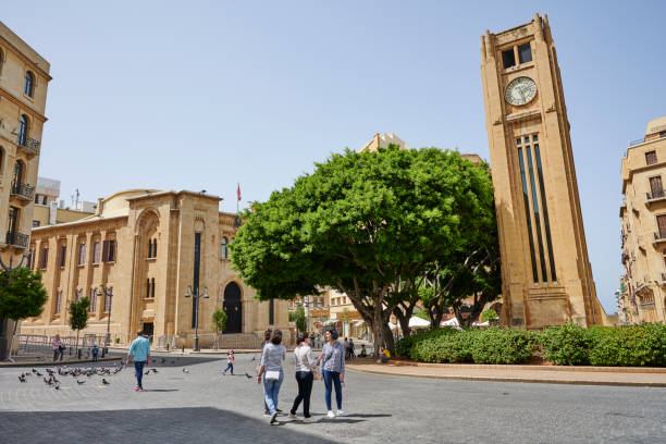 Beirut, Lebanon - April 29, 2019: people in Nejmeh square, in the heart of the Beirut City Center. The Hamidiyi Clock tower and the buildings around it were reconstructed, because they were heavily destroyed during the Civil War.