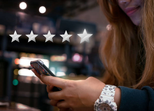 istock Hands of young woman submitting 5 star silver customer satisfaction feedback on mobile smartphone device to online shopping retailer 1165439463