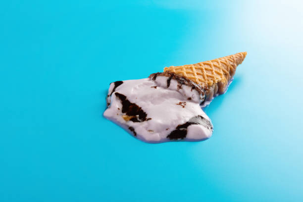 istock side view completely melted sweet potato flavor ice cream cone on a blue background 1165441478