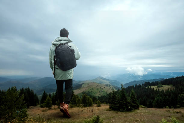 istock Creative background, A man is giant, a man is a tourist, he walks through a mountainous area with a backpack. The concept of Guliver, active tourism, recreation, the Carpathians. Mixed media 1165444323