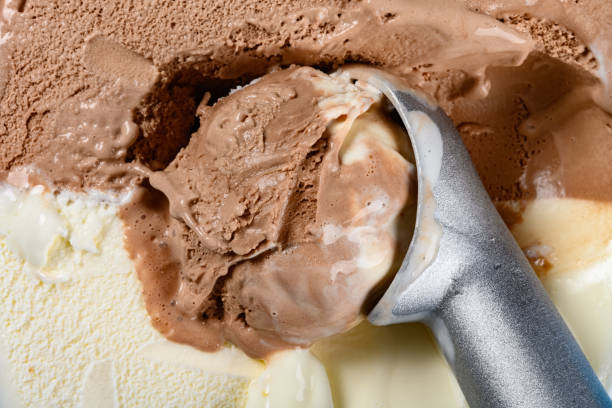 istock chocolate plus vanilla ice cream with a spoon and some digged out close up 1165447883