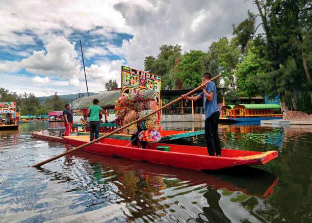 Traditional boat vendor on canals of Xochimilco Xochimilco, Mexico City, June 25, 2019 - Traditional boat sellers on canals of Xochimilco trajinera stock pictures, royalty-free photos & images