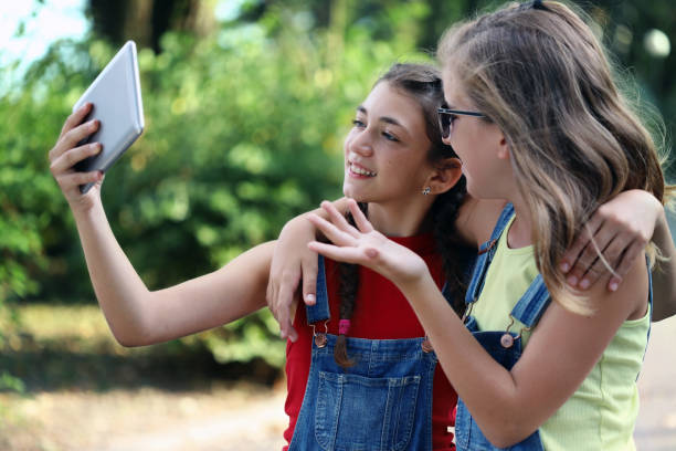 istock Two girls making selfies 1165449434