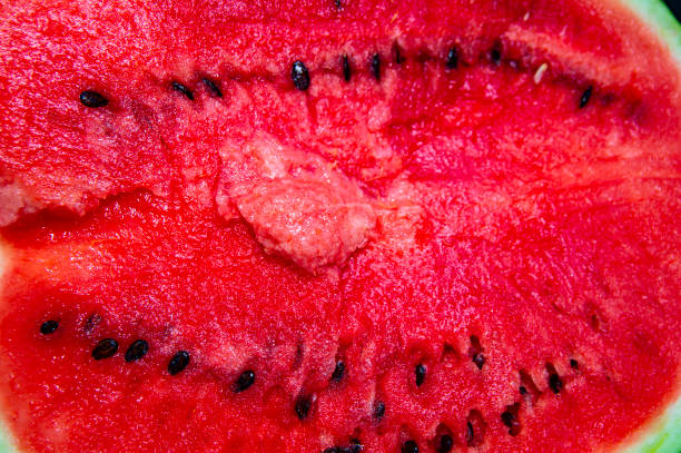 istock Red sliced watermelon on a black background. 1165451303
