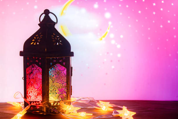 istock Ramadan Kareem. Decorative Arabic lantern with a burning candle. Festive greeting card with light effects, invitation to the Muslim holy holiday. 1165451909