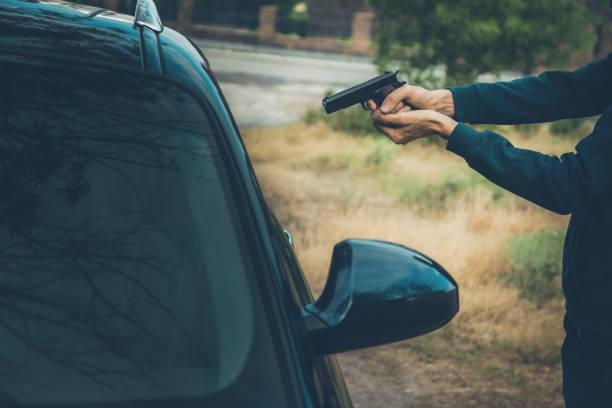istock man hand gun with car in nature 1165452748