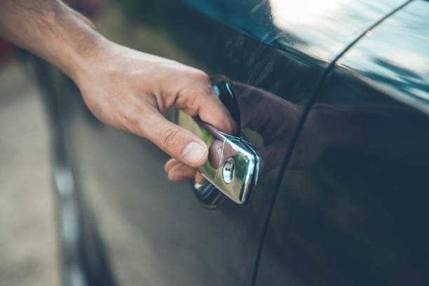 istock young man hand black car door 1165452759