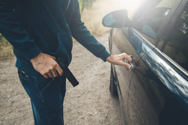 istock angry man hand gun with car door 1165452760