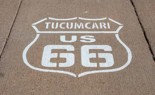 Route 66, Tucumcari US, New Mexico. Sign badge on the road, sunny day. Route 66 the classic historic roadtrip in USA