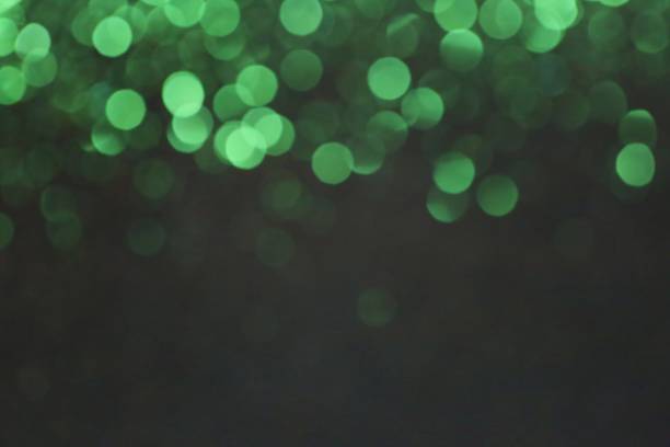istock Green abstract background with bokeh defocused lights.. green shining bokeh on black background.Christmas, New Year background. 1165456396