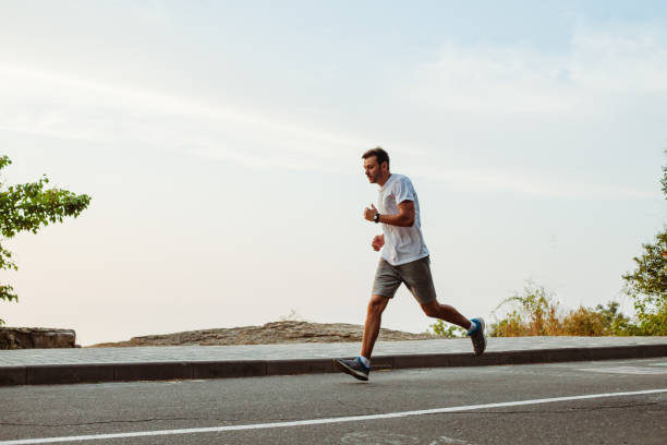 istock Man running on a city crosswalk 1165457493