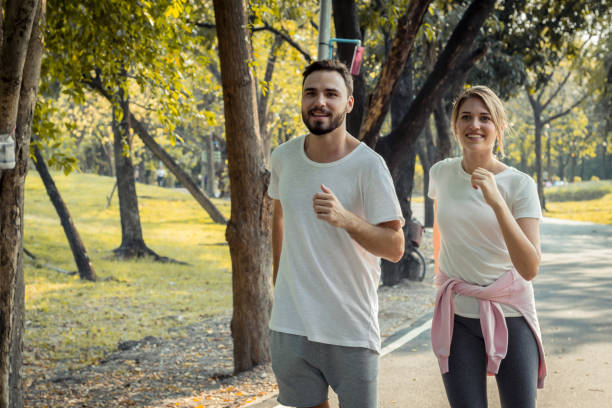 istock Couples exercise at the park in the morning. 1165459598