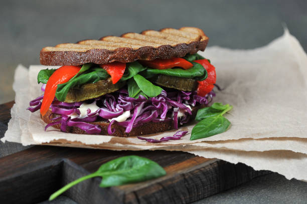 istock Veggie sandwich with red cabbage, spinach and grilled vegetables. Free space to place text. 1165460444