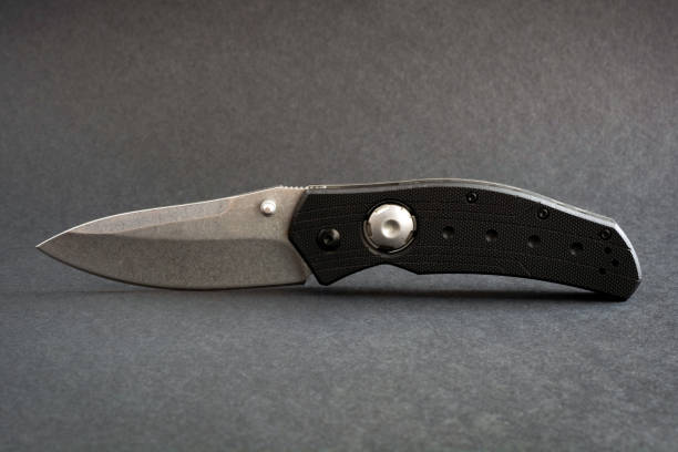 Folding pocket knife isolated on a black background. Folding pocket knife isolated on a black background switchblade stock pictures, royalty-free photos & images