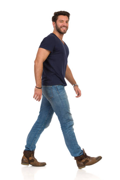 istock Smiling Walking Man In Blue T-shirt, Jeans And Boots 1165460773