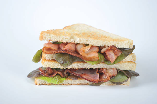 Sandwich with bacon and oaclyph lettuce on a white background. Close-up. Macro shooting.