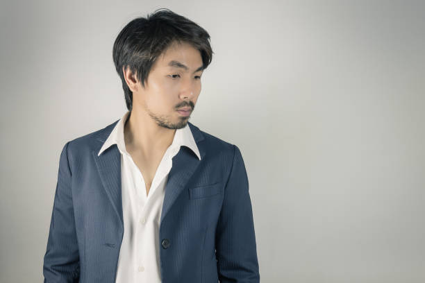 istock Portrait Man in Navy Blue Suit Looking Below Vintage Tone 1165463891