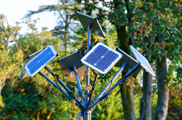 Close-up to a blue colored flower shaped solar panel with white petals, leaves and long stem with blue sky background. 3D Illustration