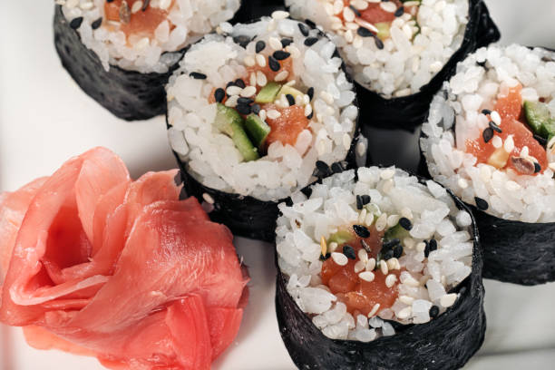 istock Set of rolls with red fish and ginger. Table setting. Black background. 1165464560