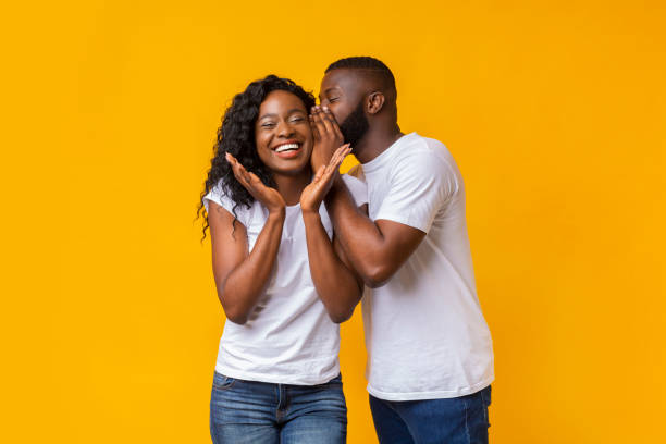 istock Afro guy whispering secrets to his girlfriend 1165464670